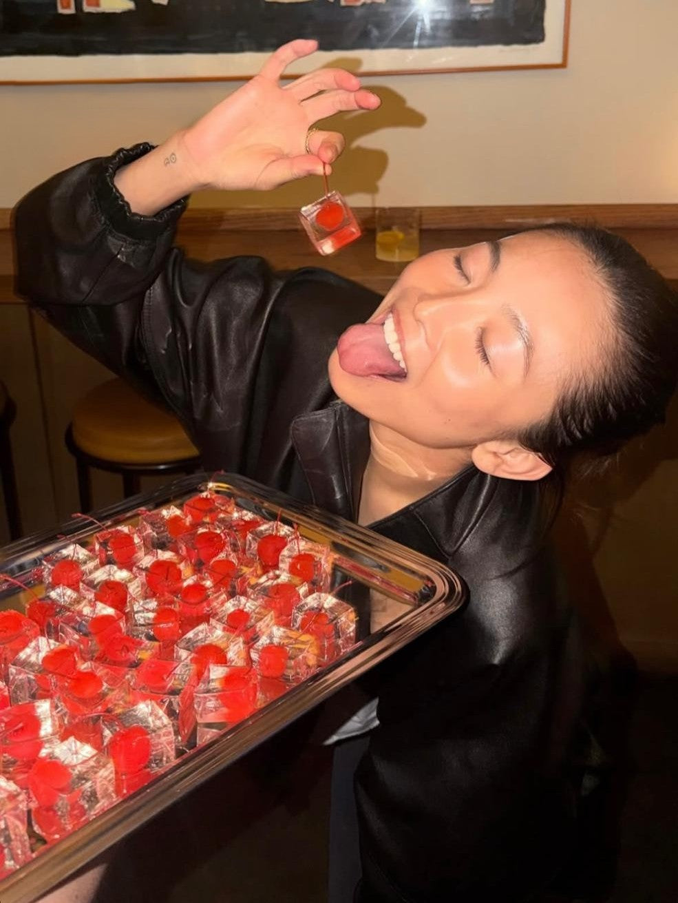 Guest tasting a handcrafted Cocktail Cherry Jelly at a luxury YIXO event.