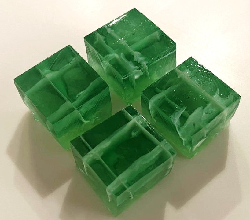 Four handcrafted Moringa Botanical Jellies with delicate white edible artwork.